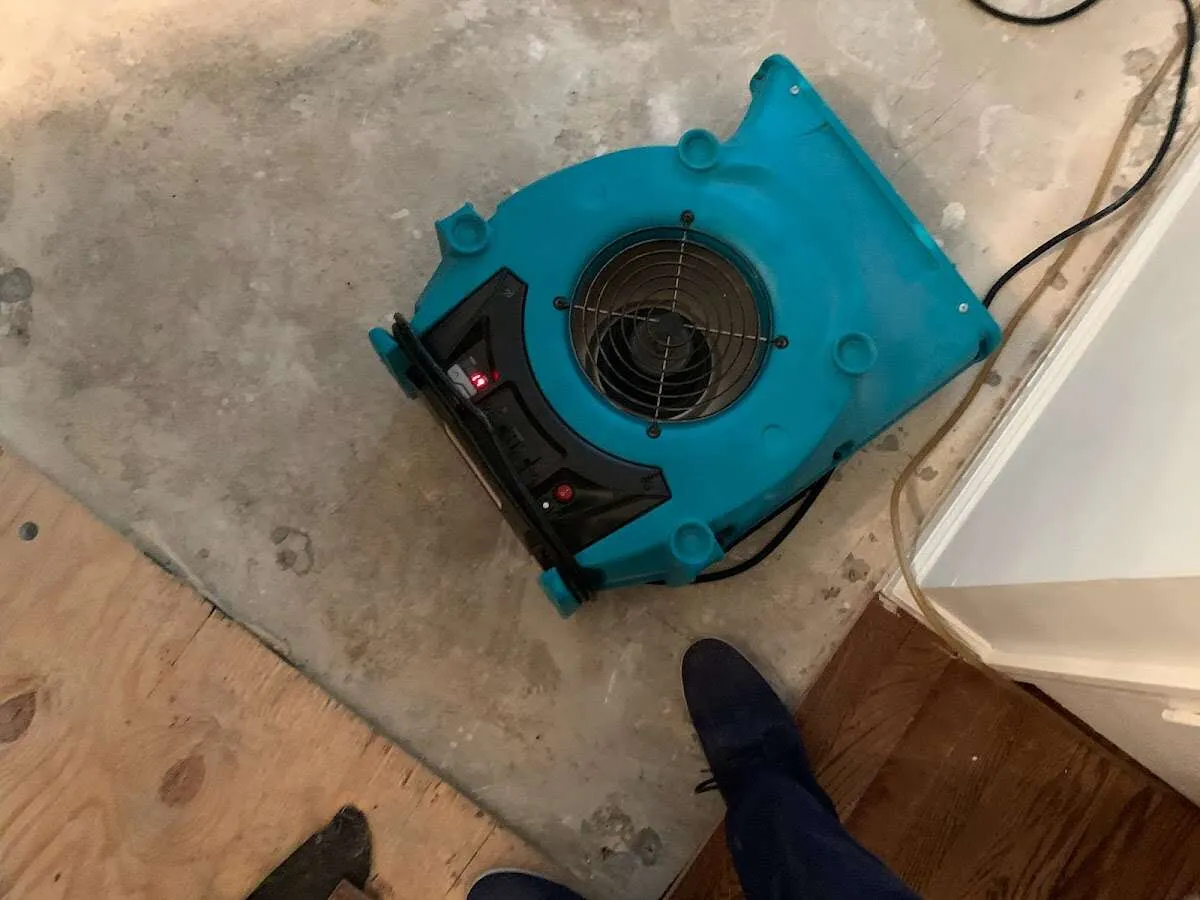 Air mover drying subfloor during Commercial Water Damage Restoration in Hempfield